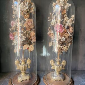 Pair of 19th century Glass domes with gilded appliqués and paper flowers.