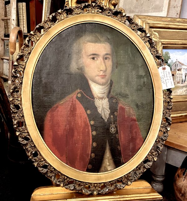 Oval portrait in oil of a Georgian gentleman in a red coat. (circa 1740)(BRHP)