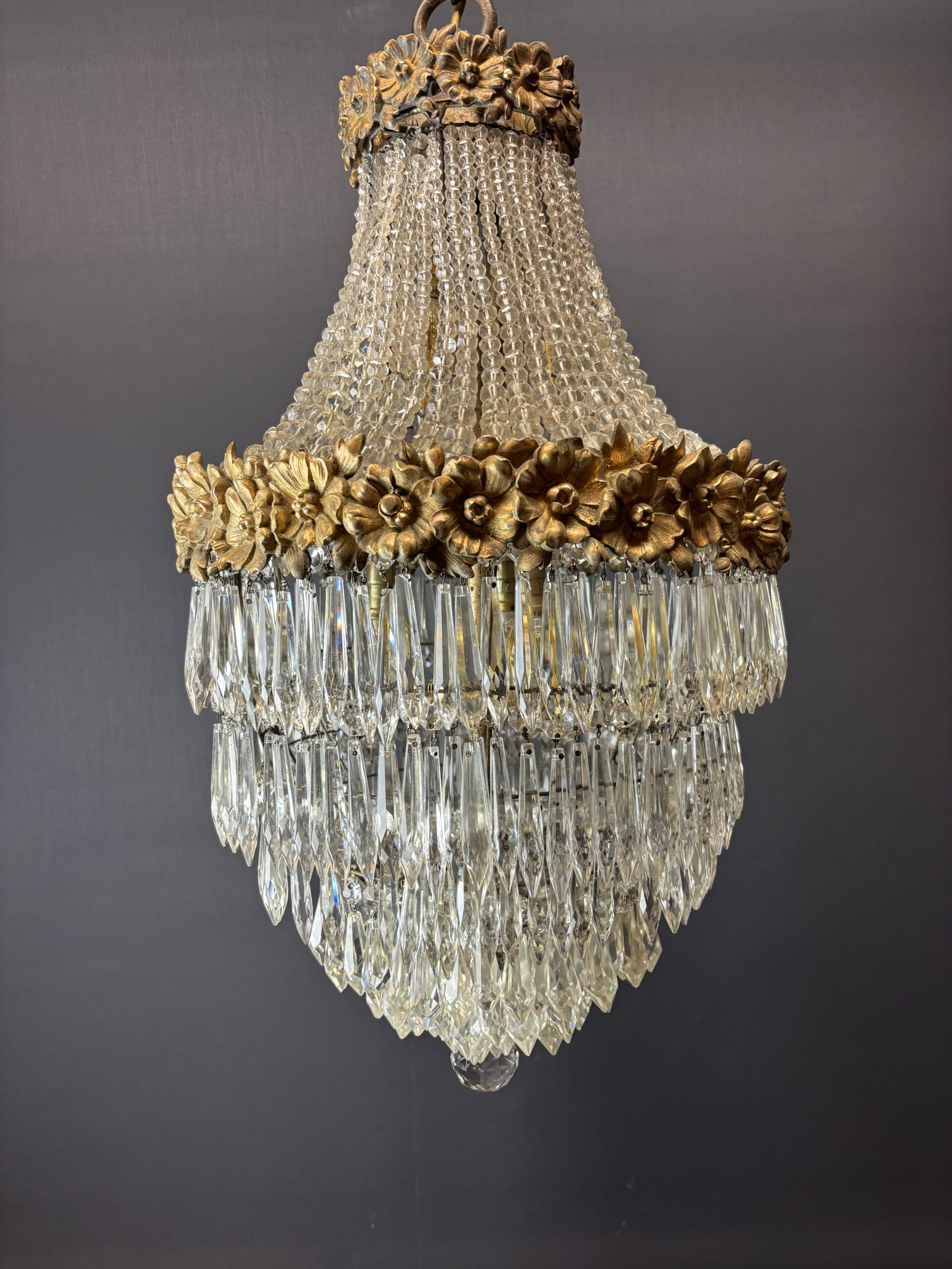 Glamorous chandelier dripping with crystals and crowned with gilded flowers. - Image 4
