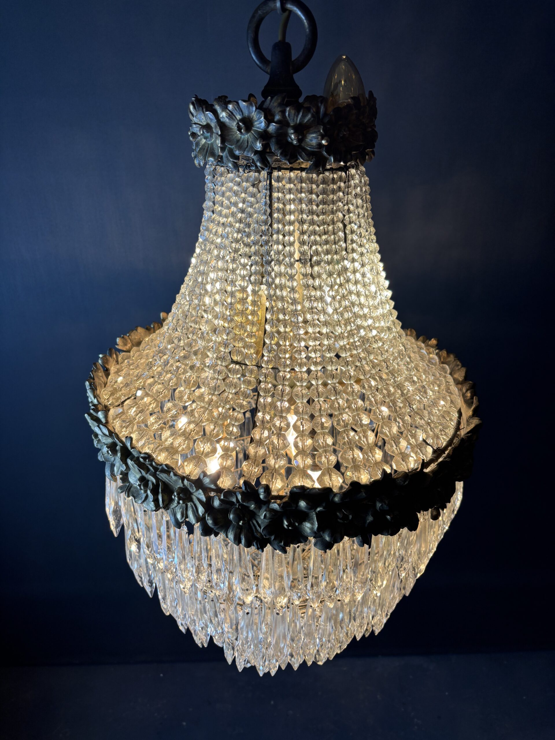 Glamorous chandelier dripping with crystals and crowned with gilded flowers. - Image 7