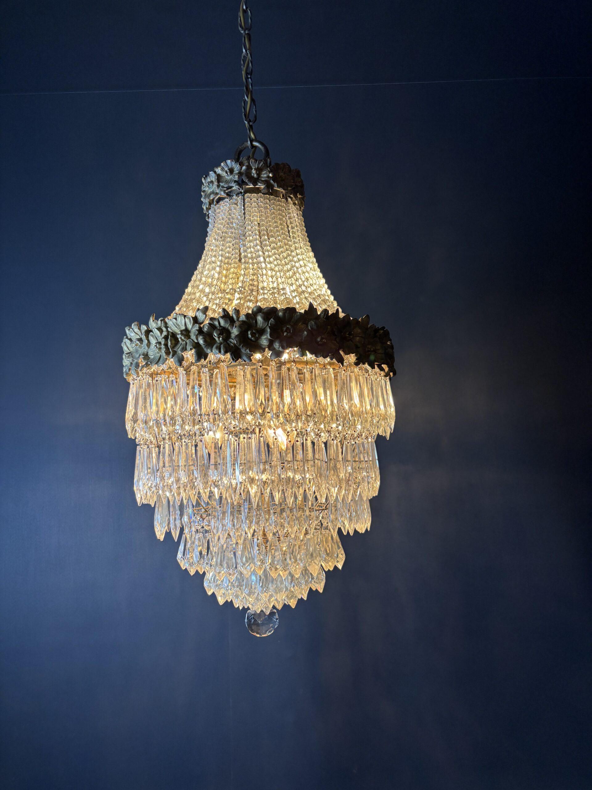 Glamorous chandelier dripping with crystals and crowned with gilded flowers. - Image 2