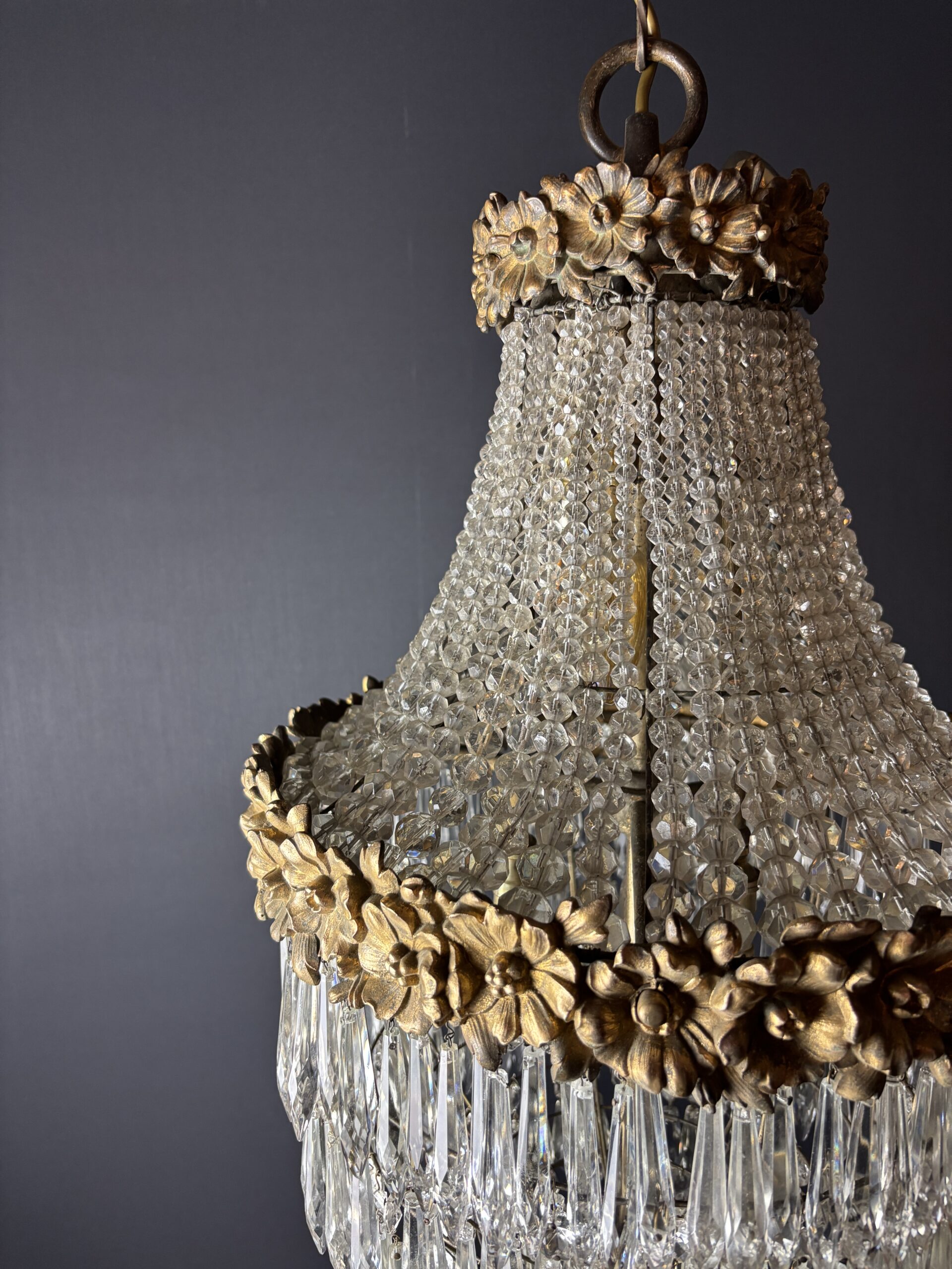 Glamorous chandelier dripping with crystals and crowned with gilded flowers. - Image 5