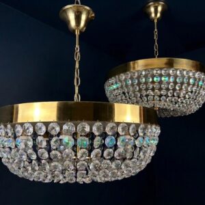 Pair of midcentury Hollywood Regency Brass and iridescent Crystal chandeliers.