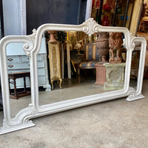 A landscape Italian painted mirror with scrollwork.
